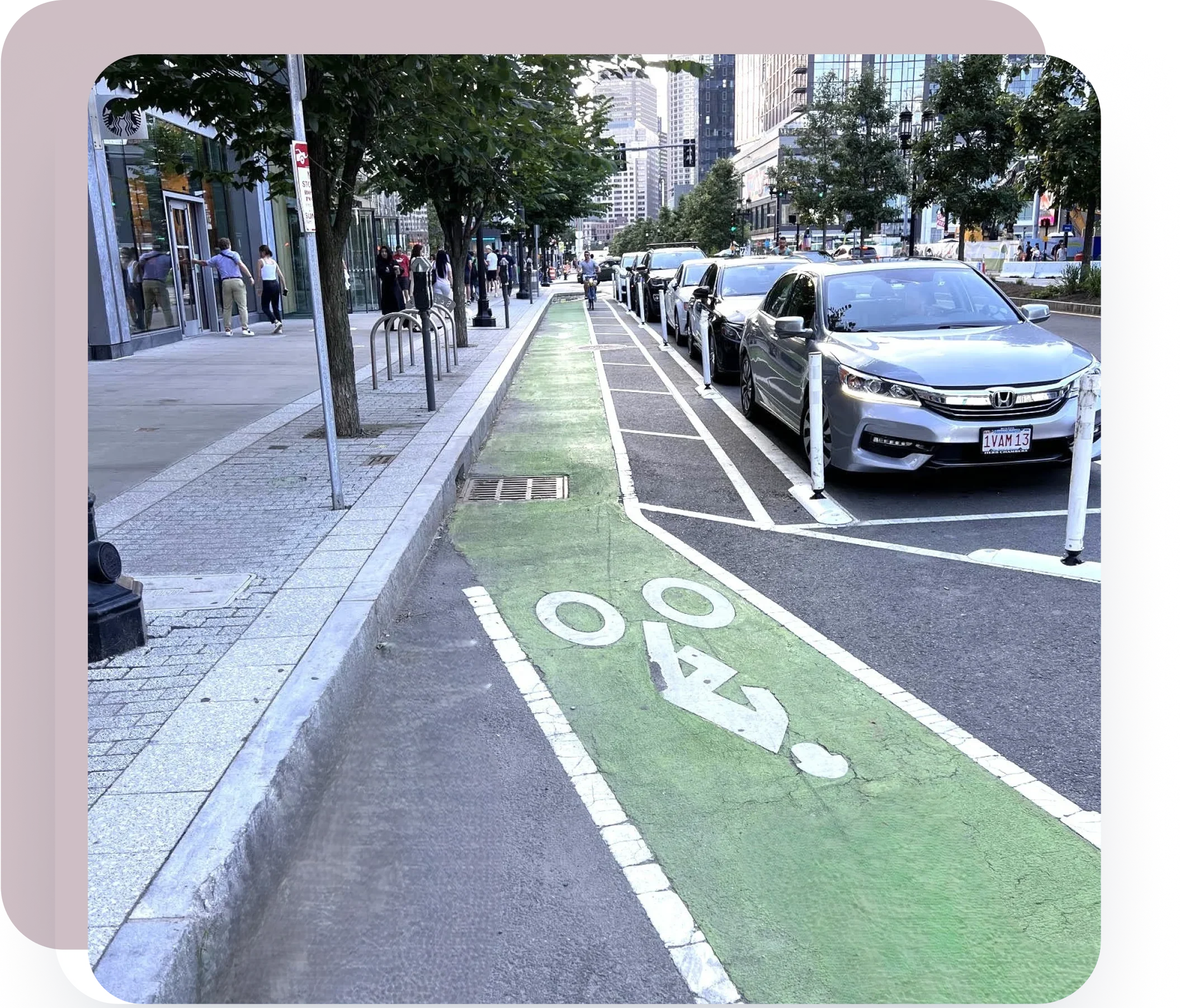 Protected green bike lane in a modern city street showcasing sustainable urban planning solutions.